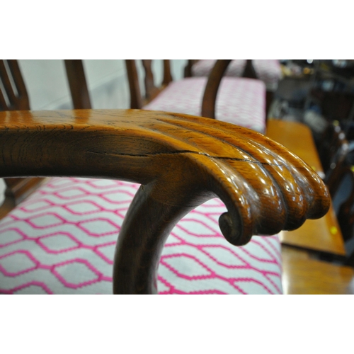 200 - A LARGE 20TH CENTURY OAK WIND OUT DINING TABLE, with three additional leaves, raised on reeded and t... 