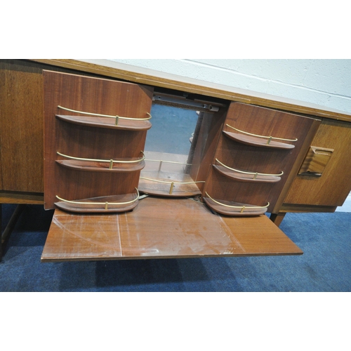 208 - A MID CENTURY TEAK SIDEBOARD, fitted with two bi-fold doors, flanking a central door, with articulat... 