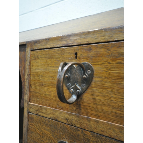 209 - LIBERTY AND CO OF LONDON, AN ARTS AND CRAFTS OAK DRESSING CHEST, with a black glass surface, sloped ... 