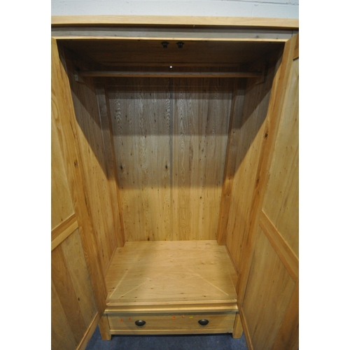 219 - A MODERN OAK DOUBLE DOOR WARDROBE, atop a base with a single drawer, width 113cm x depth 60cm x heig... 