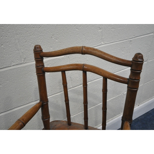 245 - A 20TH CENTURY OAK METAMORPHIC HIGH CHAIR, with open armrests, and a fold away foot rest, height 97c... 