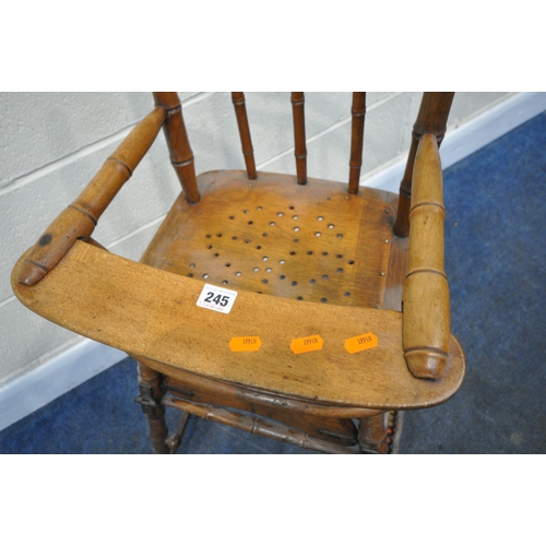 245 - A 20TH CENTURY OAK METAMORPHIC HIGH CHAIR, with open armrests, and a fold away foot rest, height 97c... 