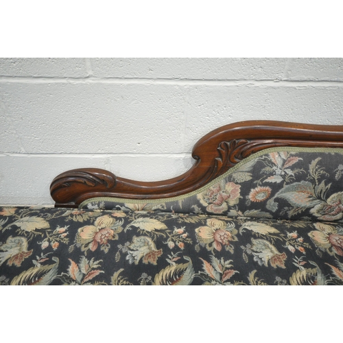 246 - A VICTORIAN ROSEWOOD CHAISE LOUNGE, with a shaped back and scrolled armrests, blue ground and foliat... 