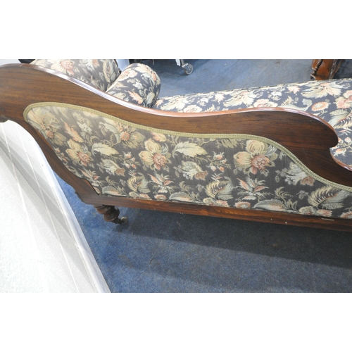 246 - A VICTORIAN ROSEWOOD CHAISE LOUNGE, with a shaped back and scrolled armrests, blue ground and foliat... 