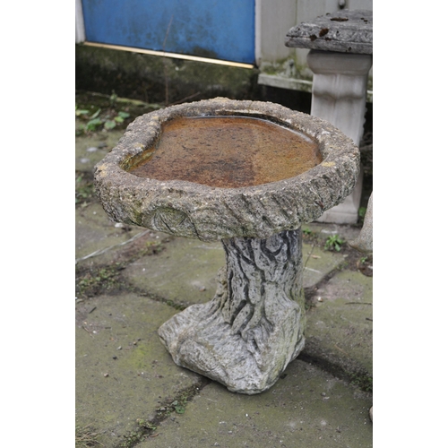 4 - FOUR WEATHERED COMPOSITE GARDEN ITEMS, to include a tree stump effect bird bath, height 40cm, a smal... 