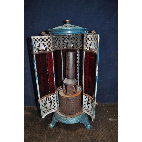 78 - A VINTAGE FRENCH CYLINDRICAL ENAMELLED CAST IRON CONSERVATORY HEATER with coloured glass panels behi... 