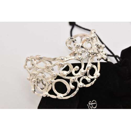 491 - TWO WHITE METAL BANGLES, the first a hinged open work cuff bangle set with cubic zirconia, signed 'B... 