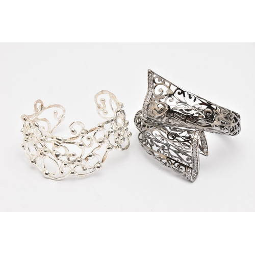 491 - TWO WHITE METAL BANGLES, the first a hinged open work cuff bangle set with cubic zirconia, signed 'B... 