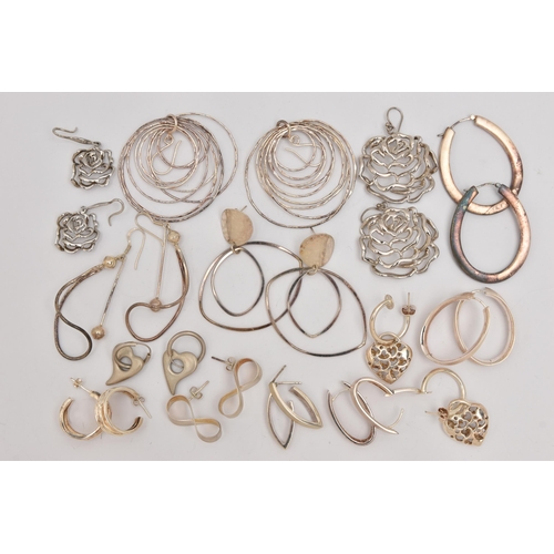 497 - AN ASSORTMENT OF SILVER AND WHITE METAL EARRINGS, to include a pair of open work floral silver earri... 