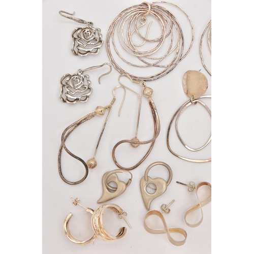 497 - AN ASSORTMENT OF SILVER AND WHITE METAL EARRINGS, to include a pair of open work floral silver earri... 