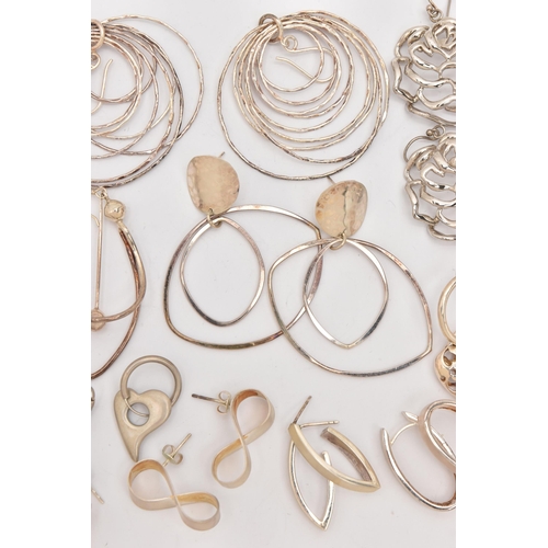 497 - AN ASSORTMENT OF SILVER AND WHITE METAL EARRINGS, to include a pair of open work floral silver earri... 