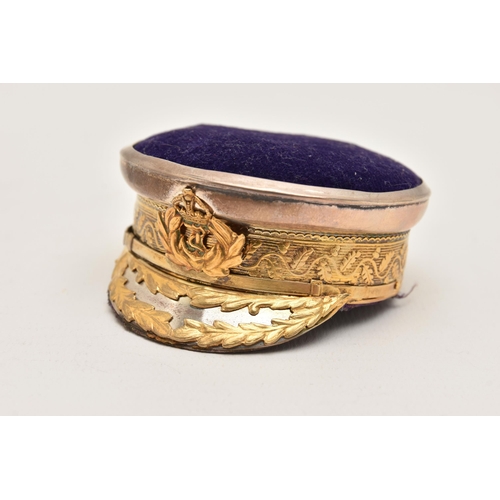 542 - AN EARLY 20TH CENTURY NOVELTY PIN CUSHION, in the form of a naval offices peak hat, gilt rim and cre... 