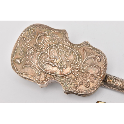 544 - A LATE VICTORIAN SILVER VIOLIN, AF one string is loose from mount, decorated with scrolling foliate ... 