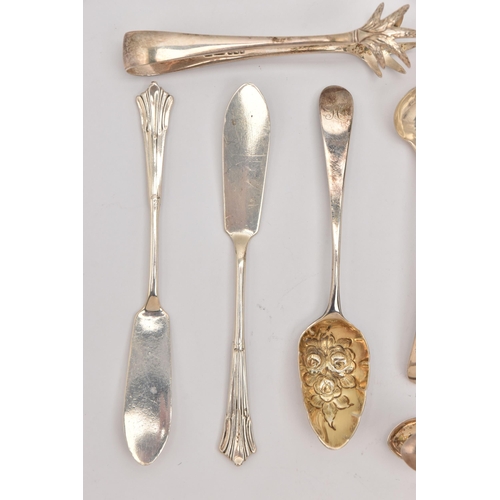 555 - AN ASSORTMENT OF SILVER CUTLERY PIECES, to include three pairs of sugar tongs, a small ladle, two ol... 