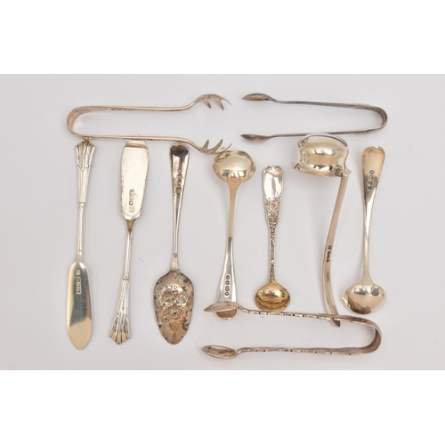 555 - AN ASSORTMENT OF SILVER CUTLERY PIECES, to include three pairs of sugar tongs, a small ladle, two ol... 