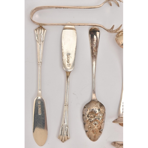 555 - AN ASSORTMENT OF SILVER CUTLERY PIECES, to include three pairs of sugar tongs, a small ladle, two ol... 