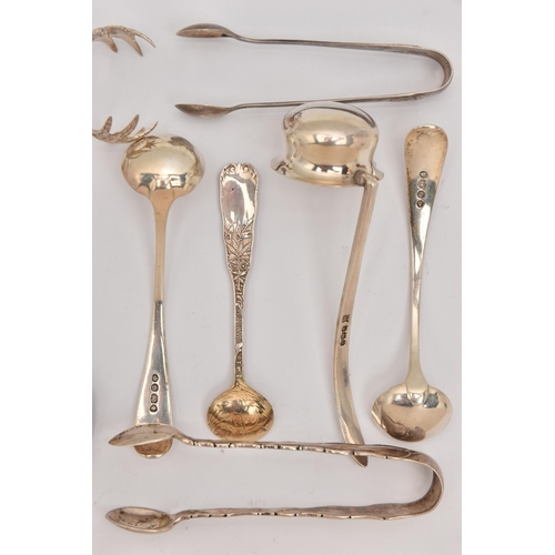 555 - AN ASSORTMENT OF SILVER CUTLERY PIECES, to include three pairs of sugar tongs, a small ladle, two ol... 