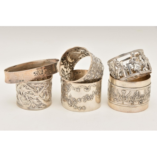 560 - ONE SILVER AND FIVE CONTINENTAL NAPKIN RINGS, to include a silver thistle detailed ring, hallmarked ... 