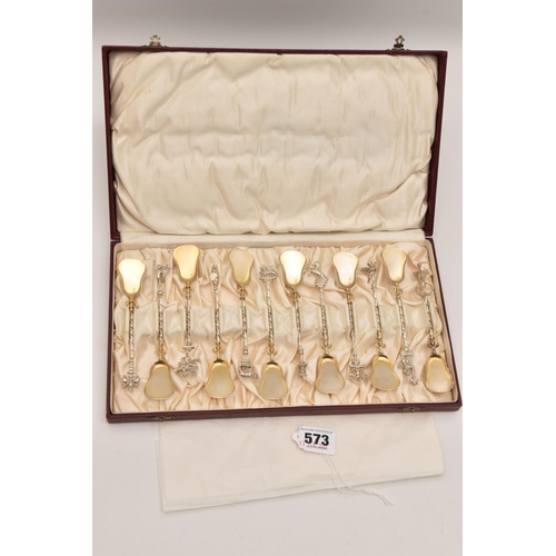 573 - A CASED SET OF TWELVE CONTINETAL TEASPOONS, each with a gilt bowl, twisted stems each with a differe... 