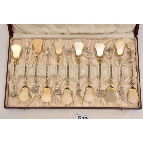 573 - A CASED SET OF TWELVE CONTINETAL TEASPOONS, each with a gilt bowl, twisted stems each with a differe... 