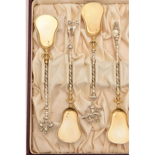 573 - A CASED SET OF TWELVE CONTINETAL TEASPOONS, each with a gilt bowl, twisted stems each with a differe... 