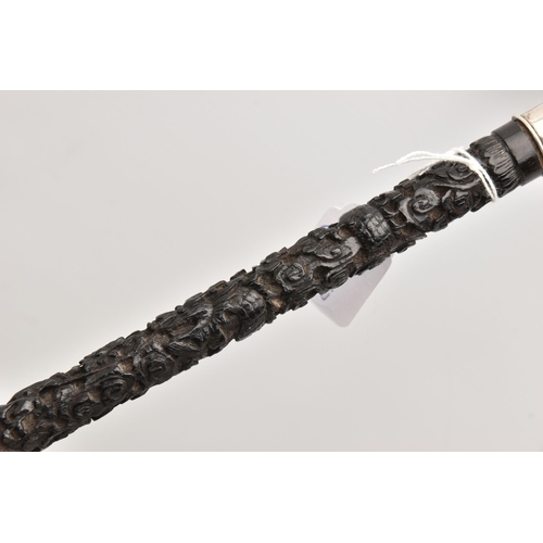 579 - A LATE 19TH / EARLY 20TH CENTURY CHINESE HARDWOOD WALKING CANE WITH SILVER HANDLE, the handle with f... 