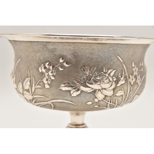 581 - AN EARLY 20TH CENTURY CHINESE SILVER PEDESTAL BOWL, embossed with a floral pattern on a textured bac... 