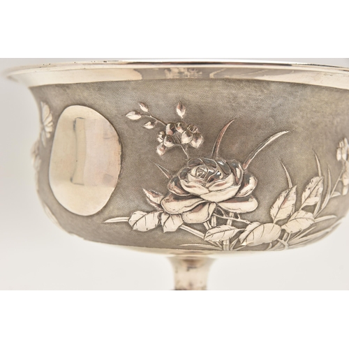 581 - AN EARLY 20TH CENTURY CHINESE SILVER PEDESTAL BOWL, embossed with a floral pattern on a textured bac... 