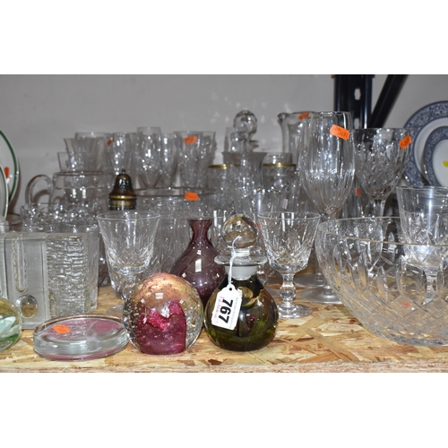 767 - A COLLECTION OF GLASSWARE, to include a quantity of cut glass drinking glasses,  decanters, large de... 