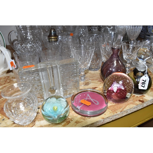 767 - A COLLECTION OF GLASSWARE, to include a quantity of cut glass drinking glasses,  decanters, large de... 