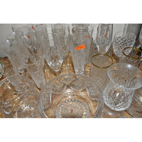 767 - A COLLECTION OF GLASSWARE, to include a quantity of cut glass drinking glasses,  decanters, large de... 