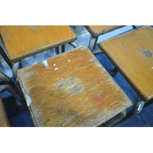 145 - A HARLEQUIN SET OF EIGHT STOOLS, with oak seats, raised on tubular metal legs, height 44cm, conditio... 