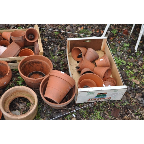 11 - A QUANTITY OF TERRACOTTA GARDEN ITEMS, including a chimney topper, various pots of different sizes a... 