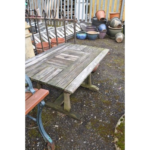 23 - A MODERN CAST IRON ENDED GARDEN BENCH with slatted wood seat and back (feet have raisers welded to t... 