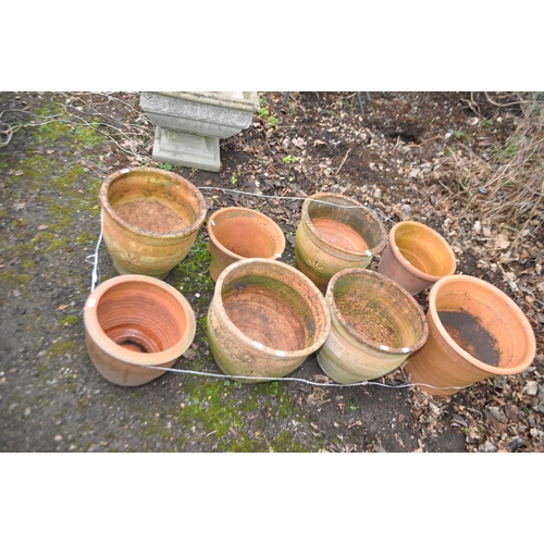 38 - A COLLECTION OF EIGHT TERRACOTTA AND COLOURED GARDEN POTS the largest being  38cm high and stamped Y... 