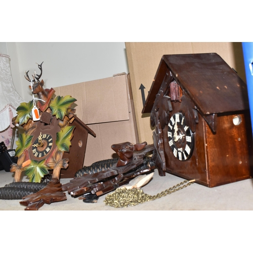 907 - TWO CUCKOO CLOCKS, traditional German cuckoo clock decorated with green painted leaf design and at t... 