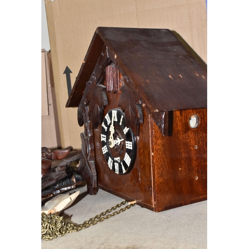 907 - TWO CUCKOO CLOCKS, traditional German cuckoo clock decorated with green painted leaf design and at t... 