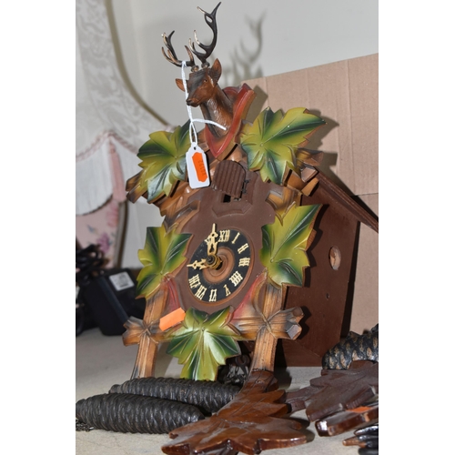 907 - TWO CUCKOO CLOCKS, traditional German cuckoo clock decorated with green painted leaf design and at t... 