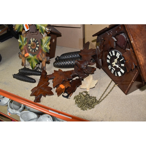 907 - TWO CUCKOO CLOCKS, traditional German cuckoo clock decorated with green painted leaf design and at t... 