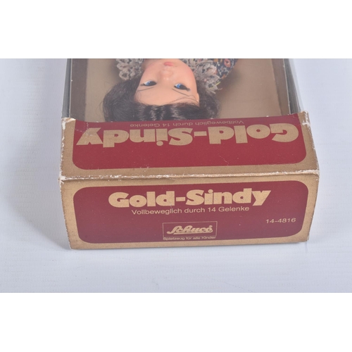 50 - A BOXED SCHUCO GOLD-SINDY, No.14-4816, appears complete with both necklaces and stand and in very go... 