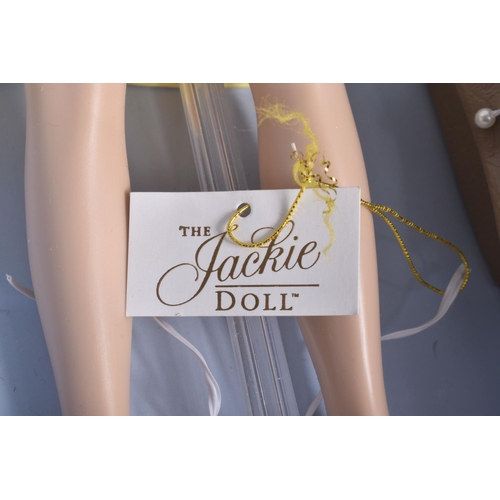 54 - A BOXED FRANKLIN MINT 'THE JACKIE DOLL', vinyl Jackie Onassis doll in yellow satin two piece outfit ... 