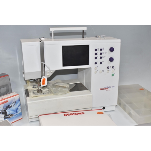 999 - A BERNINA SEWING MACHINE,  'Artista' 180 electric sewing and embroidery machine, together with manua... 