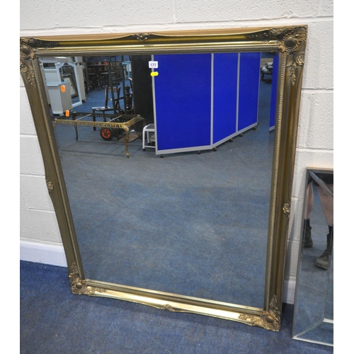 177 - A LARGE RECTANGULAR GILT FRAME BEVELLED EDGE WALL MIRROR, with foliate details, 129cm x 106cm, along... 