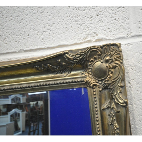 177 - A LARGE RECTANGULAR GILT FRAME BEVELLED EDGE WALL MIRROR, with foliate details, 129cm x 106cm, along... 