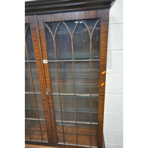 183 - A REPRODUCTION MAHOGANY BOOKCASE, with double glazed doors, that are enclosing five glass shelves, o... 