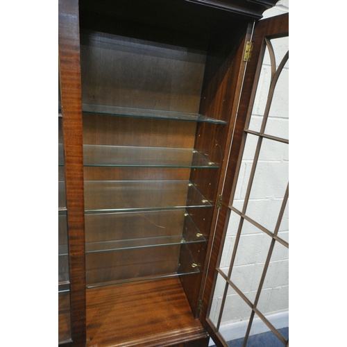 183 - A REPRODUCTION MAHOGANY BOOKCASE, with double glazed doors, that are enclosing five glass shelves, o... 