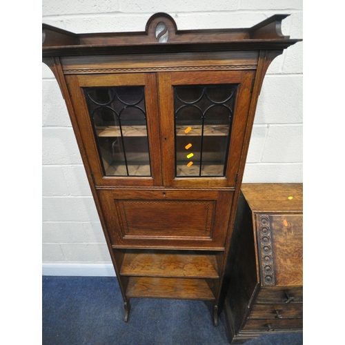 185 - AN EARLY 20TH CENTURY OAK BUREAU, the fall front door enclosing a fitted interior, above three drawe... 