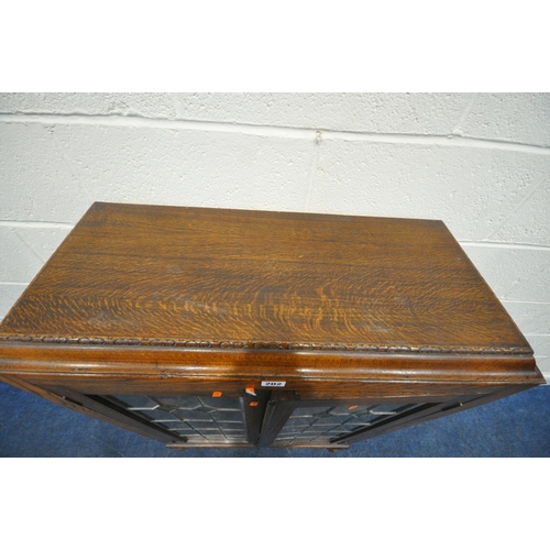 202 - A 20TH CENTURY OAK BOOKCASE, with double lead glazed doors, raised on cabriole legs, width 76cm x de... 