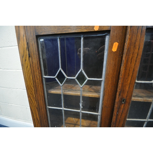 202 - A 20TH CENTURY OAK BOOKCASE, with double lead glazed doors, raised on cabriole legs, width 76cm x de... 