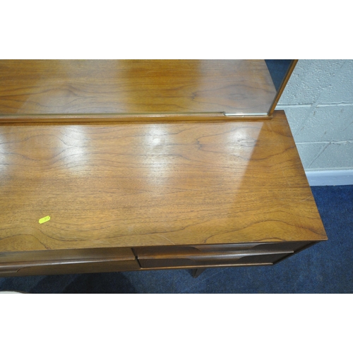 217 - AUSTINSUITE, A MID CENTURY TEAK DRESSING TABLE, with a rectangular mirror, six drawers, raised on ta... 